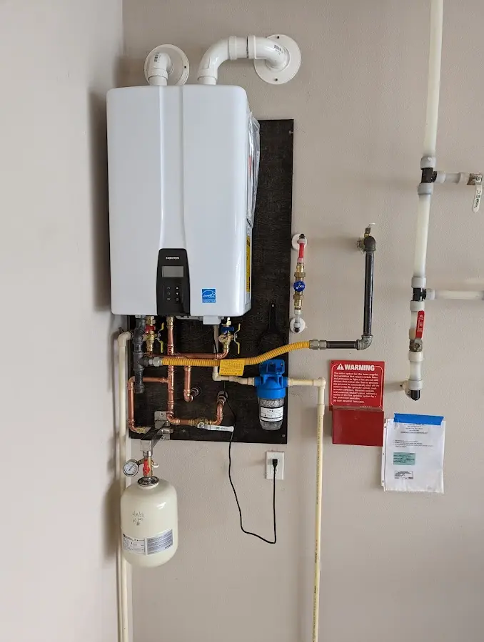 Professional plumber installing copper piping in a Bayside home